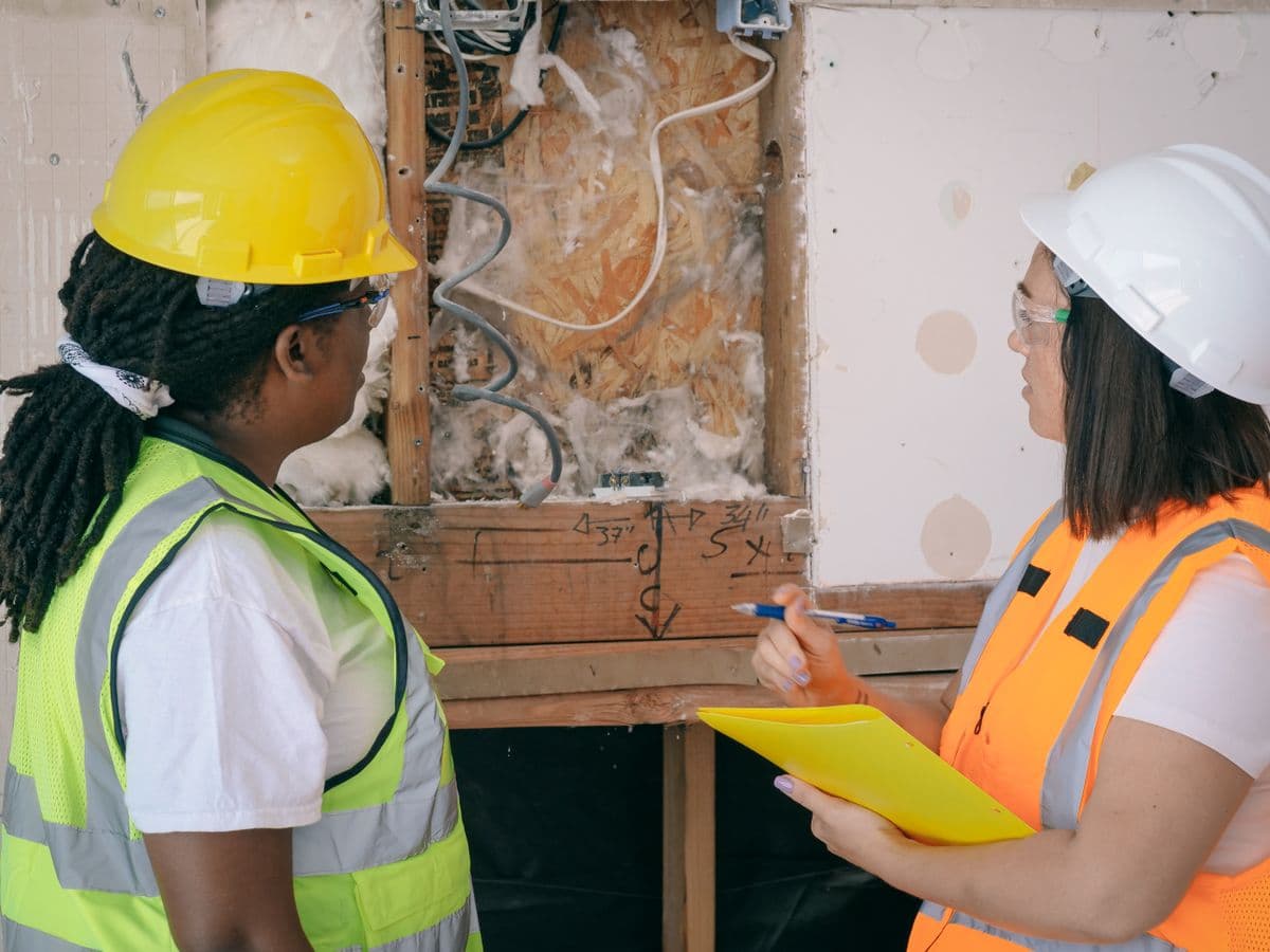 Contractors reviewing an inventory list on a jobsite